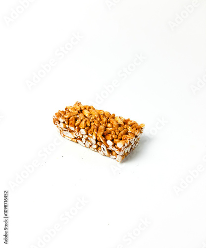 Jipang or berondong is indonesian traditional snack. Made from rice, corn coated with sweet caramel. Isolated white background photo