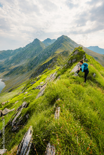 Hiking in Fagaras mountains on Iezerul Caprei peak over Transfagarasan serpentine road carpathian mountains. Mountains landscape photo