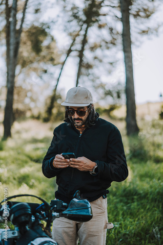 Hombre con barba y estilo alternativo con moto de campo en paso de bosque 