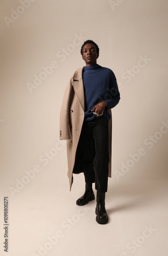 Young African American man posing over light background. Vertical mock-up.