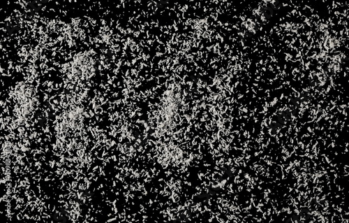 Grated coconut isolated on black, top view