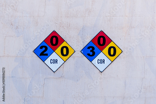 NFPA compliance hazard signs. COR means Corrosive, 2 means Hazardous, and 3 means Extreme Danger. The zero in the red square indicates Will not Burn, and the zero in the yellow square means Stable.