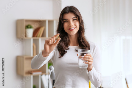 Smiling young woman holding...