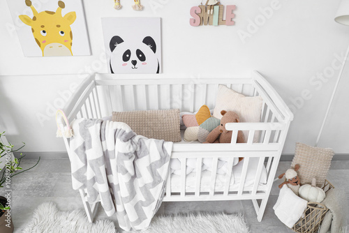 Stylish white crib with pla...