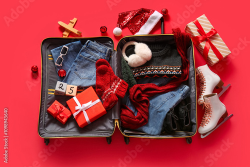 Open suitcase with winter c...