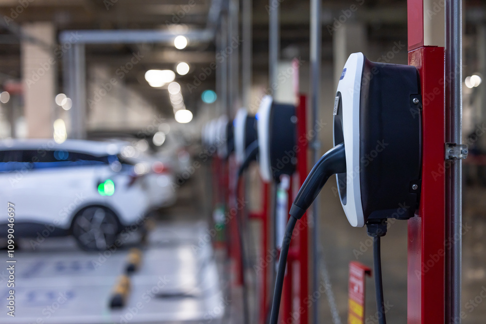 EV charger and electric car, Electric car charger station for charge ev battery, Plug for vehicle with electric engine, EV charger clean energy, Charging point at car parking lot department store.