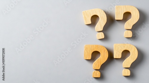 Three wooden blocks with question marks on a gray surface inviting curiosity and exploration of new ideas and possibilities in creative thinking photo