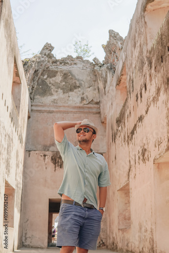 Happy Asian man standing inside of Tamansari ruin building, Yogyakarta. photo