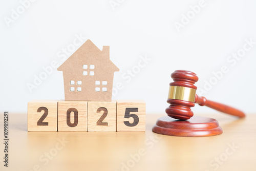 Happy New Year 2025 with small toy house model with gavel justice hammer on desk in courthouse. Real Estate Law, Home Insurance, property Tax, Auction and Bidding concepts photo