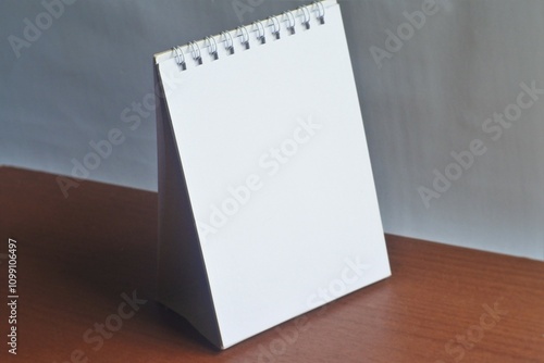 blank notebook on white background. blank calendar on the desk