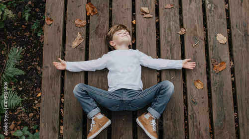 Boy Lying on Wooden Deck in...
