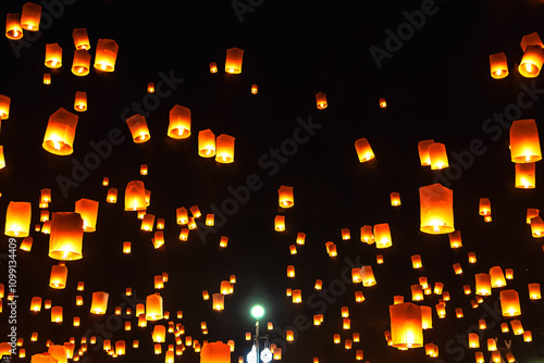 Colorful fire Lanna lantern reasing into sky during Loi Kratong festival in Chiangmai photo