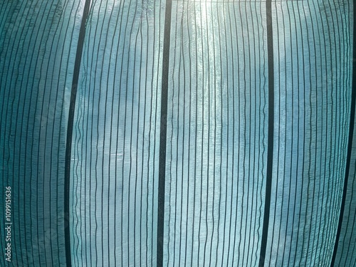 Green shading net was spread over the walkway in the market, allowing a glimpse of the bright sunlit sky