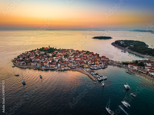 Obraz na płótnie Primosten, Croatia - Aerial view of Primosten peninsula and old town on a sunny summer morning in Dalmatia, Croatia with yachts, blue and golden sky at sunrise on the Adriatic sea coast w salonie
