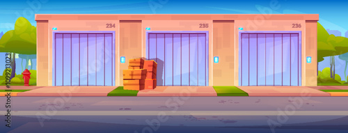Pink building exterior of self storage units with purple doors set on blue sky. Stack of boxes placed near middle entrance. Green bushes and red hydrant in background. Personal storehouse business.