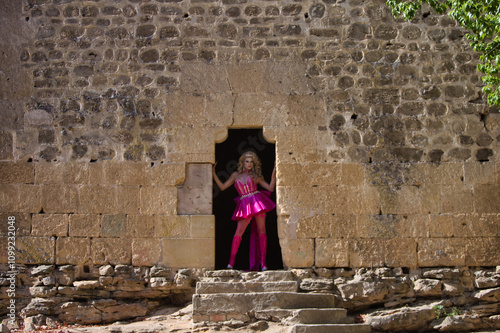 eccentric blonde drag queen dressed in pink, in a medieval castle. Concept of equality and lgtbqi+ rights and gay pride. Gender identity photo