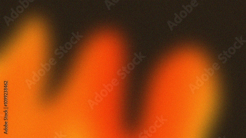 Tableau sur toile A vibrant abstract image featuring blurred gradients of orange and red tones blending into a dark background, evoking a sense of warmth and mystery