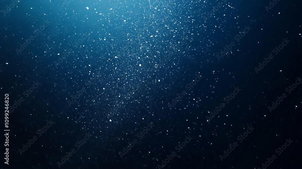 Obraz premium Snowflakes Falling Against Dark Blue Background