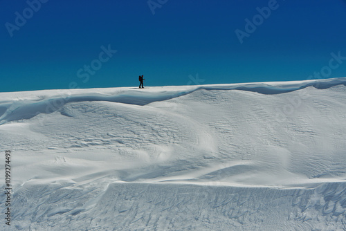 man on ski climbing snow patagonia chile touring top backcountry cornice photo