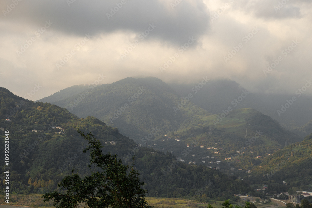 Fototapeta premium The Misty Mountains rise majestically under Cloudy Skies, inspiring wonder and adventure