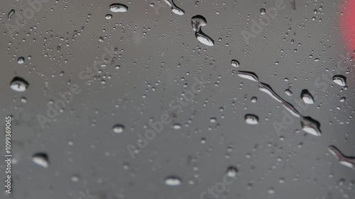 heavy rain slow motion on car window while driving