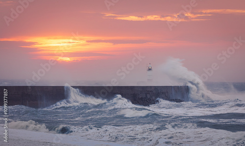 Storm Bert at dawn at Newhaven lighthouse west beach on the east Sussex coast south east England UK