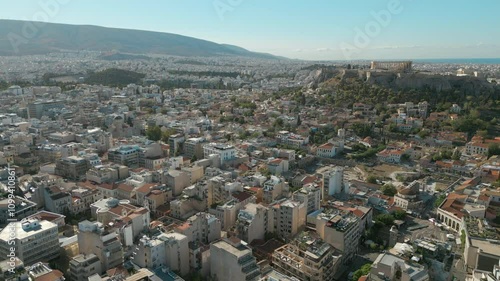 Acropolis Of Athens Greece Slow Drone Pull Back Across Low Rise Rooftops 4K 60FPS photo