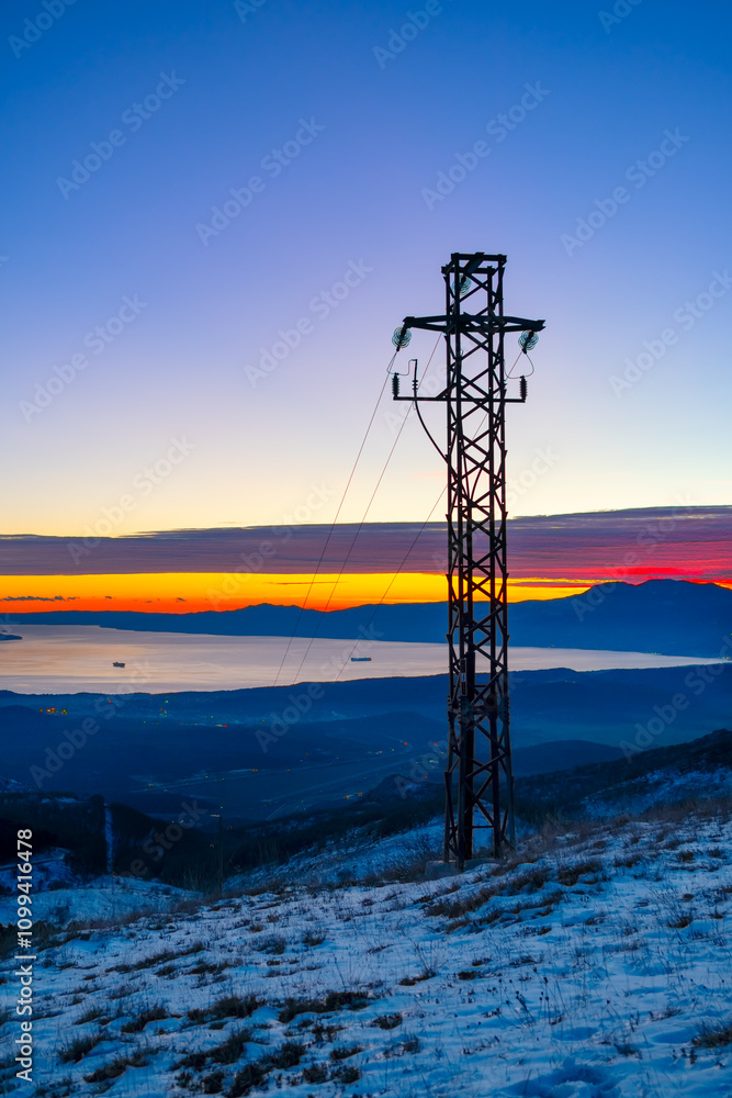 Vertical view of the high voltage power lines on the mountain against ...