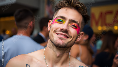 Gay man with rainbow eyeshadow winking at camera