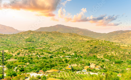 wonderful mountain landscape of great amazing mountains with greel slopes and hills and beautiful blue cloudy sky on background photo