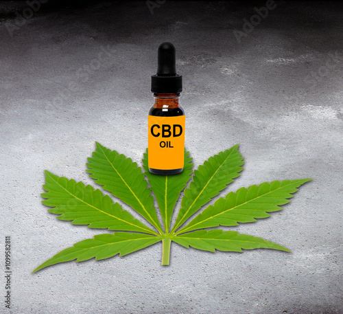 CBD oil and cannabis leaf, composite image photo