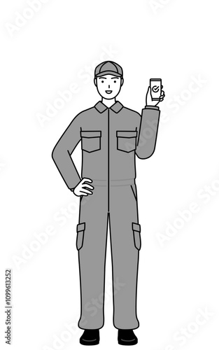 A mechanic in coveralls using a smartphone at work.