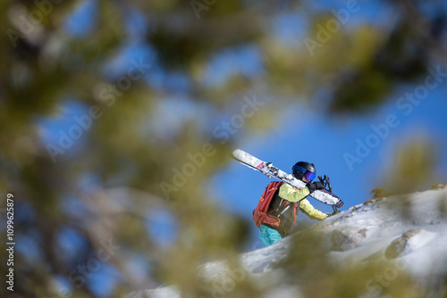 Ski Enthusiast Hiking Up a Mountain for an Adventure photo