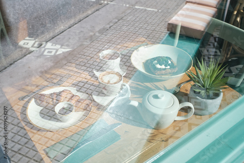 Cozy coffee scene with pastries and tea on a sunlit table photo