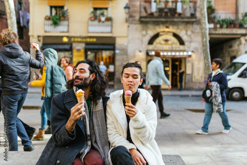 Photography Gay couple enjoying ice cream cones in barcelona city center