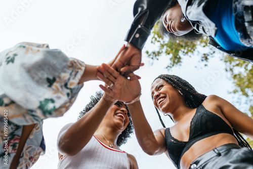 women joining hands, celebrating diversity and inclusion photo