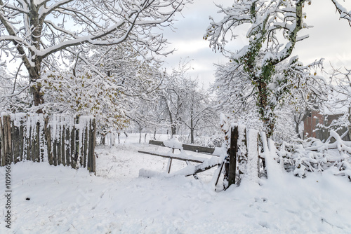 An old wooden yard covered in snow