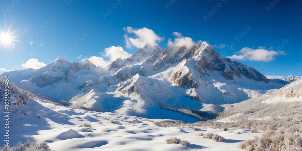 Obraz premium Snow-covered mountains under a clear blue sky in winter landscape