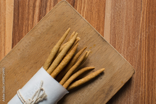 Top view of fried corn stick snack on a wood board, Overhead view of nigerian kokoro corn snack photo