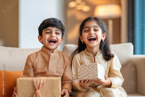 indian girl and boy holding gift box photo