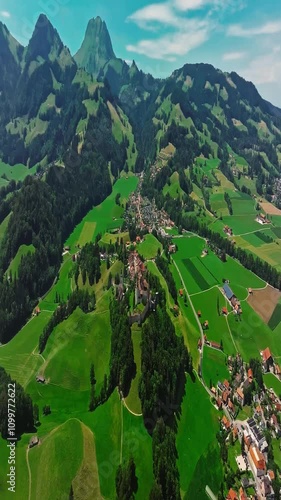 Medieval Swiss castle aerial view in summer. A drone flies through a green valley in the Swiss mountains. Famous Gruyere castle in Switzerland also called Schloss Greyerz, aerial shot by drone photo