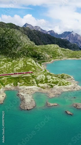 Wallpaper Mural Aerial view of red train moving amidst breathtaking natural views Switzerland, vertical video. Torontodigital.ca