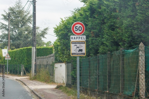 Speed limit reminder sign along a road in Dordogne France photo