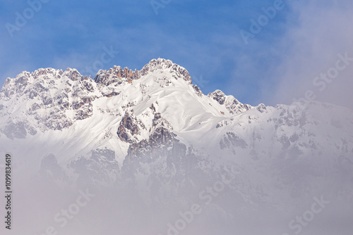 Snowy Mountain Peaks in Fog