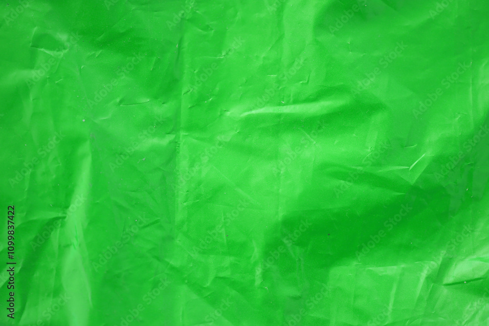 Fototapeta premium Texture of Green color plastic bag smooth crumpled surface