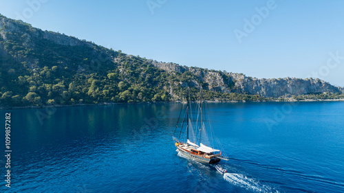 Εκτύπωση καμβά A gulet ship anchored near turquoise waters, with green hills in the background, creating a serene and picturesque scene