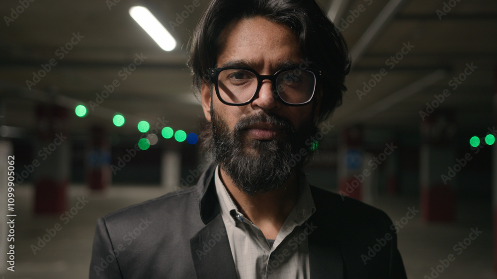 Fototapeta premium Stressed frustrated Indian man in underground parking lot suffering from tension disappointed male businessman feeling headache upset by stress crisis business problem failure bankruptcy heartbroken