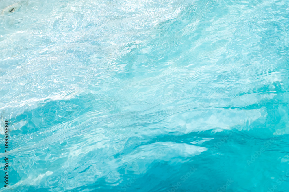 Fototapeta premium Closeup Transparent blue clear water surface texture with ripples. Abstract​ of​ surface​ blue​ splashes and bubbles​ water waves reflected​ with​ sunlight​