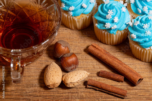 Cinnamon almond nut Christmas Holiday cupcakes with a cup of tea arranged on a wooden serving tray