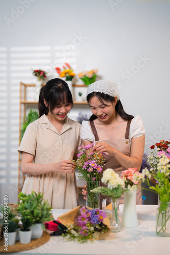 Two florists working together to arrange flowers in a vase, creating a vibrant and artistic display amidst a cozy flower shop setting